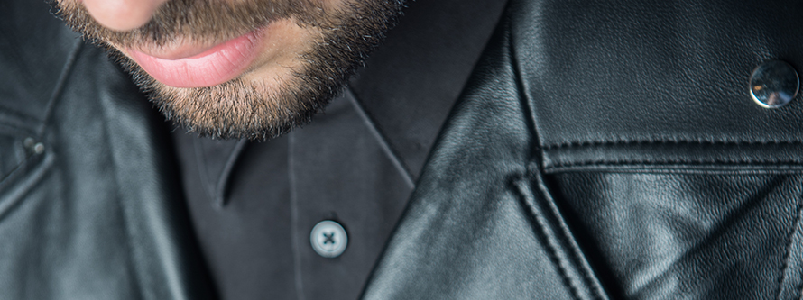 A classic black leather jacket with premium buckle details and silver studs.