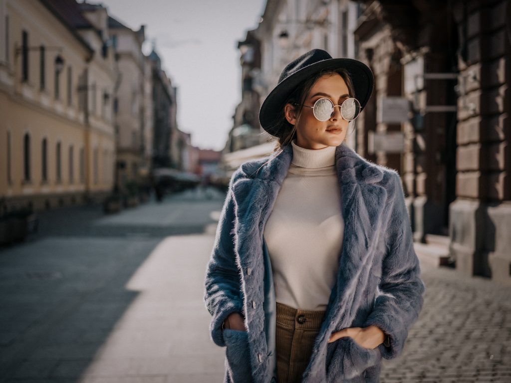 A woman showcasing Street style trends in wearing the fur coat with a vibrant mink jacket