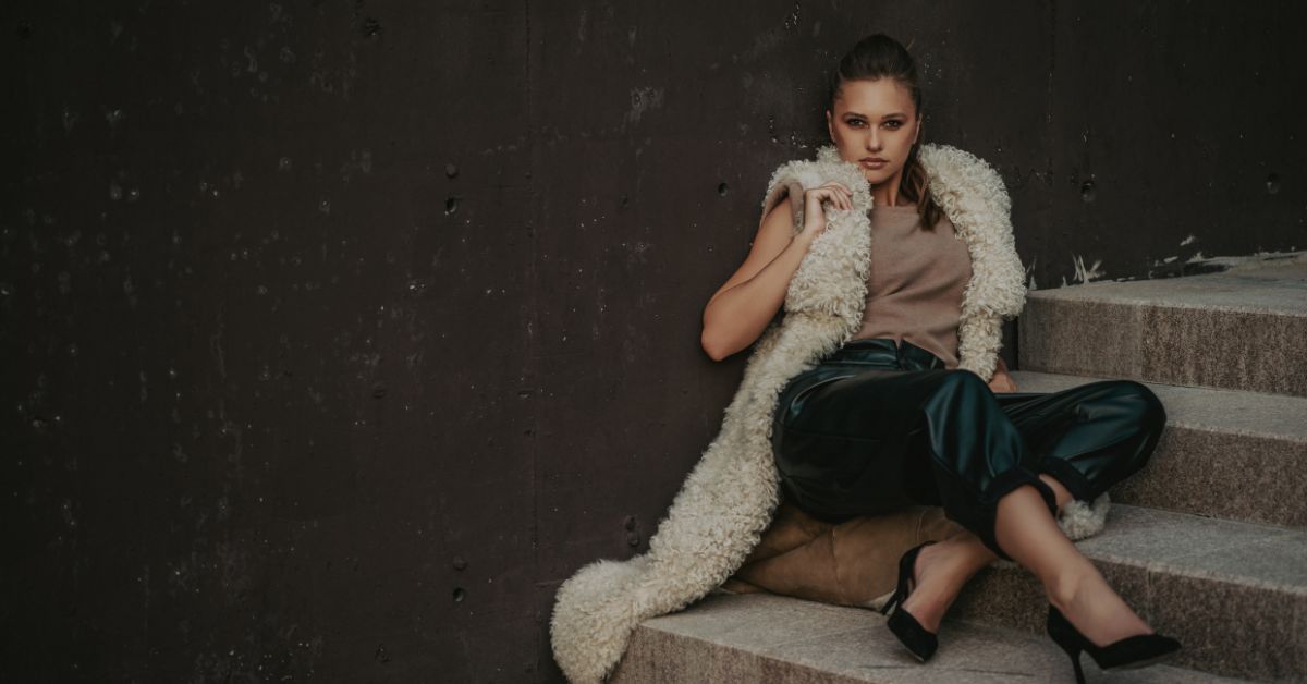 A stylish fur sheepskin vest paired with leather pants and a turtleneck sweater.