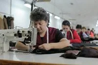 Skilled seamstress crafting natural fur garments